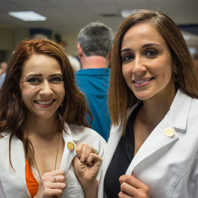 Two nursing graduates at ACC nurse pinning ceremony