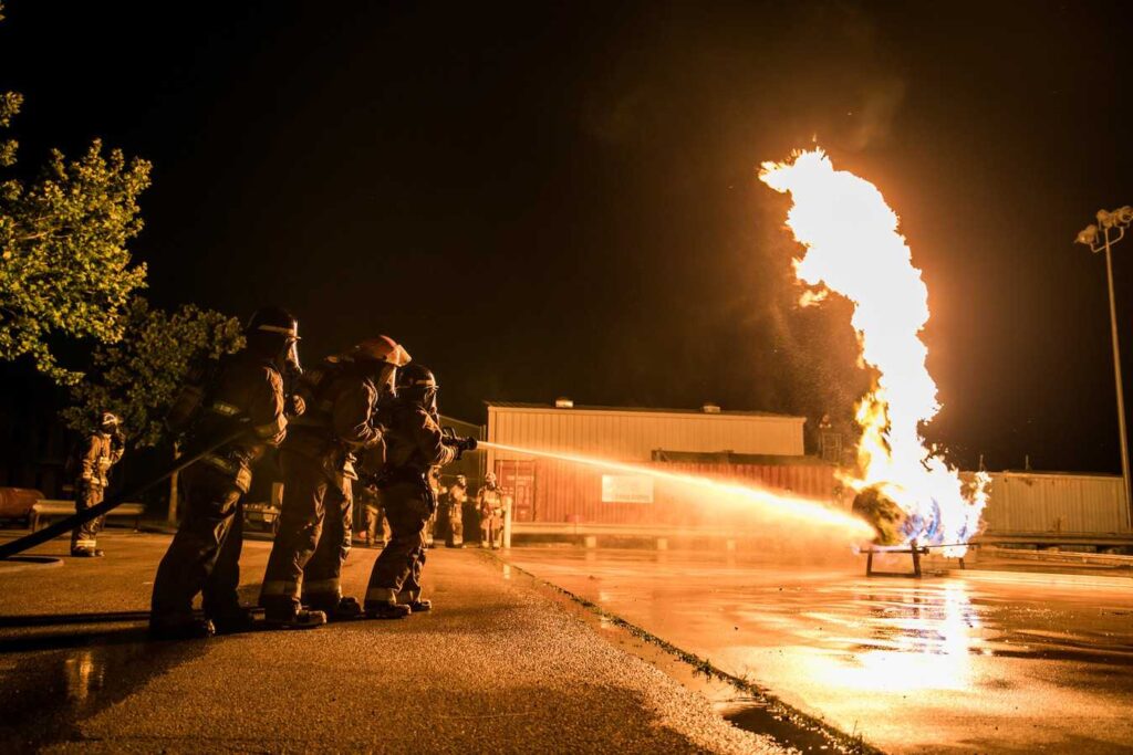ACC Fire Academy Students practice putting out fire during training.