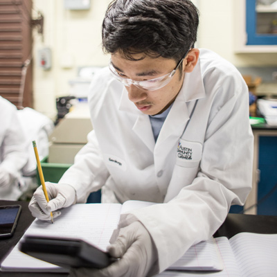 An ACC student works in a biotech lab during an internship work session.
