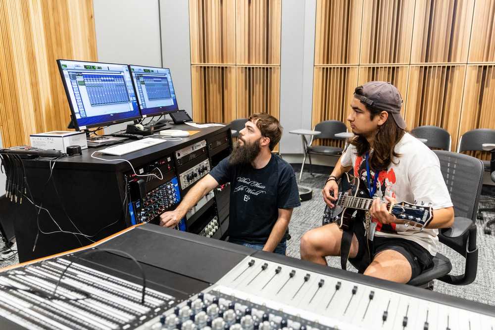 ACC students record and edit music inside of ACC Highland's student recording studio. 