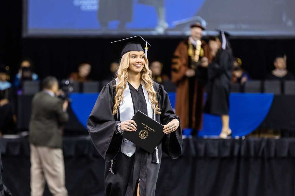 An ACC graduate walks the stage during an ACC commencement ceremony. 