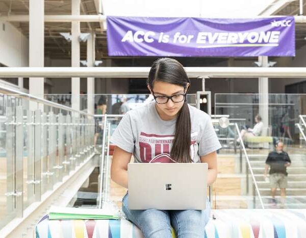 Student sitting in a study area at Highland campus working on her laptop.