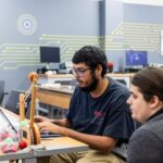 Two students work on a project in the Bachelor of Applied Technology Manufacturing classroom.