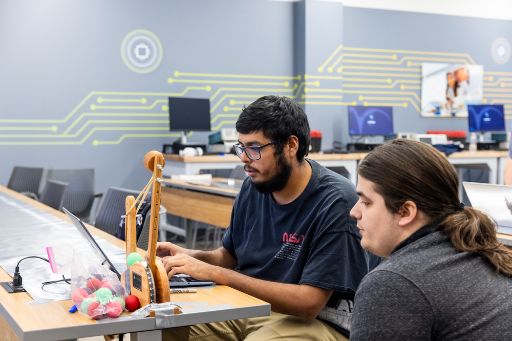 Two students work on a project in the Bachelor of Applied Technology Manufacturing classroom.